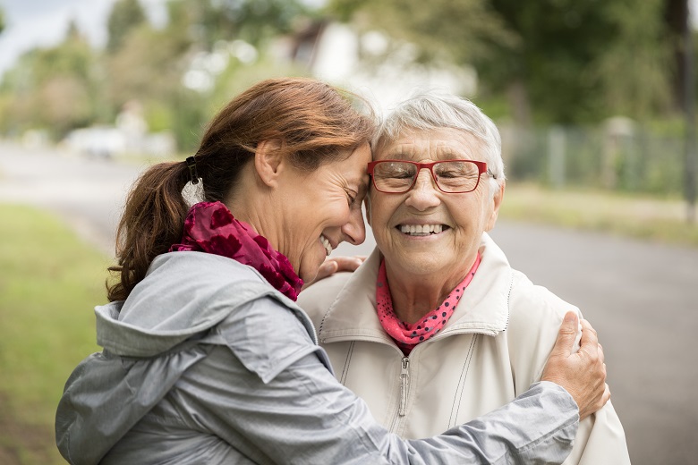 Happy senior woman and caregiver